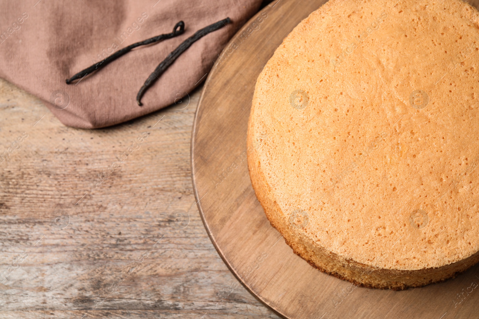 Photo of Delicious fresh homemade and napkin cake on wooden table, flat lay