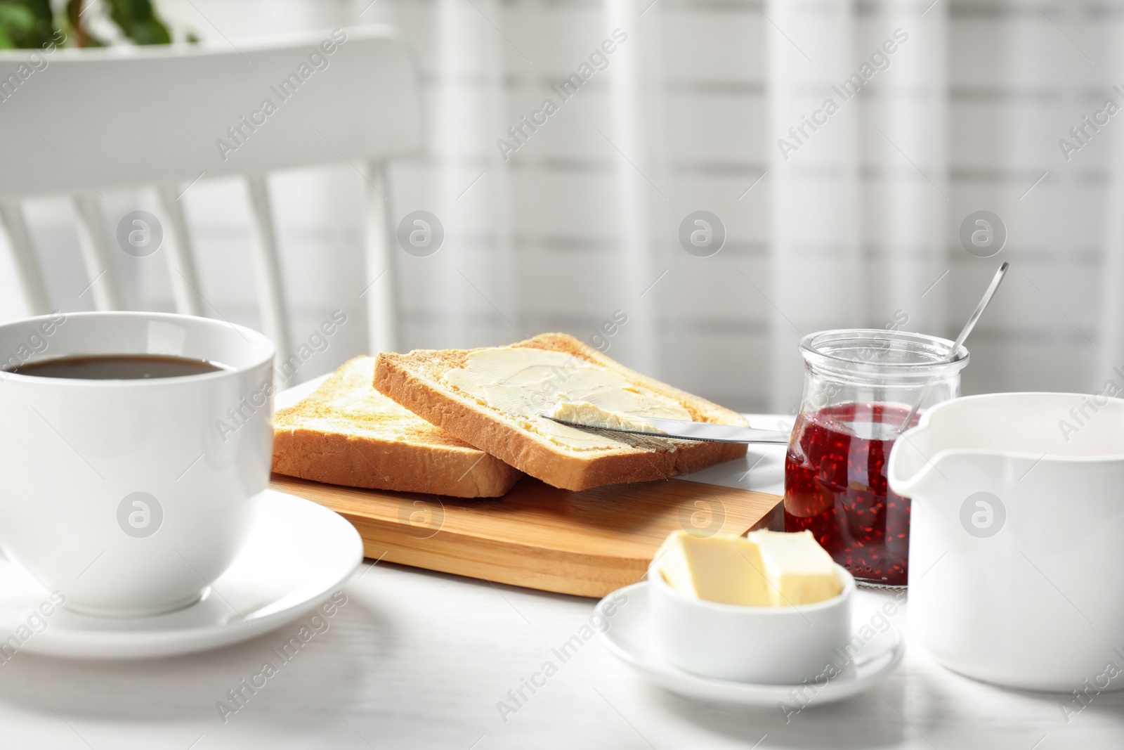 Photo of Tasty breakfast with toasts served on white wooden table