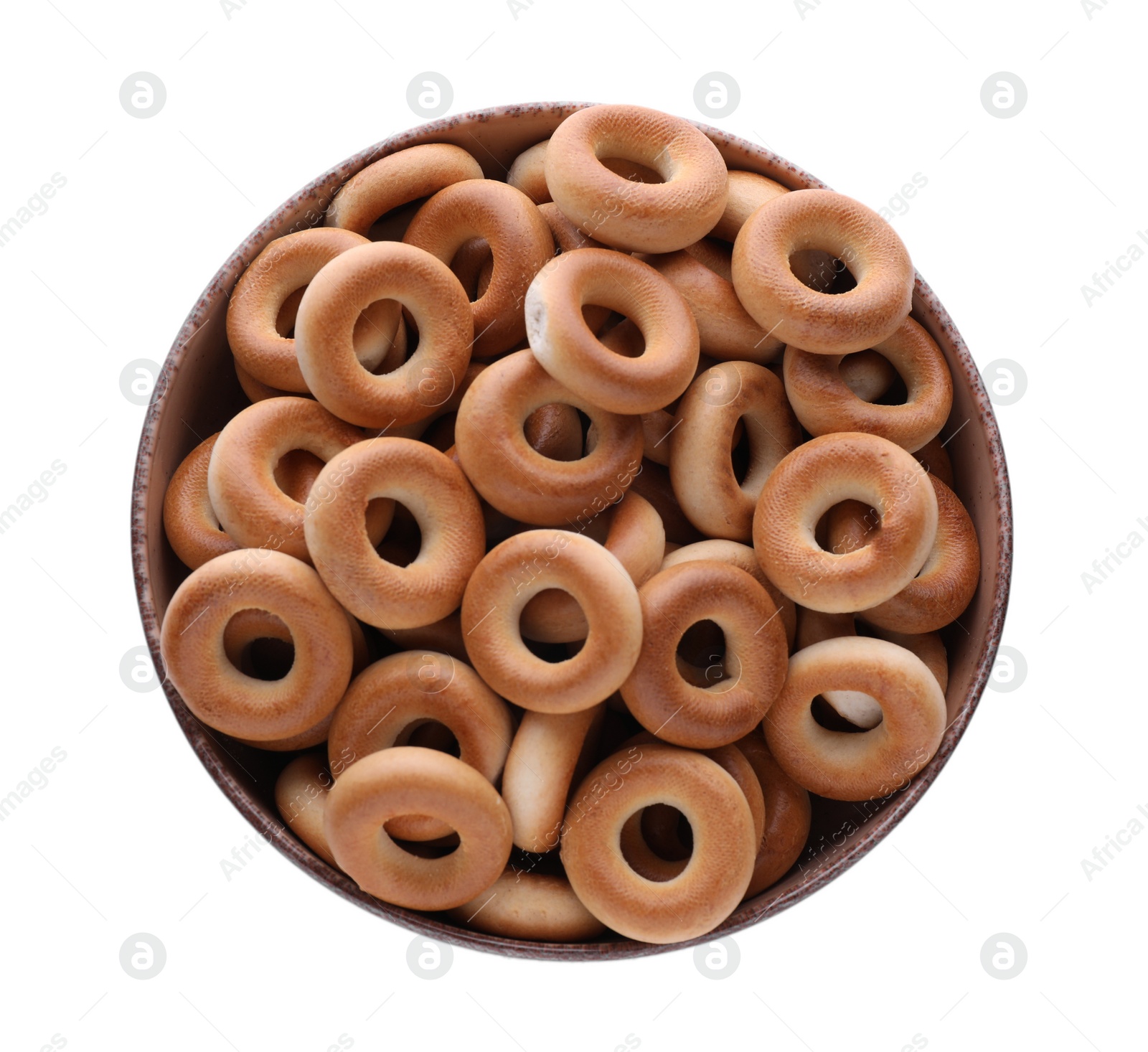 Photo of Bowl with tasty dry bagels (sushki) isolated on white, top view