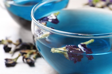 Photo of Glass cup of organic blue Anchan, closeup. Herbal tea