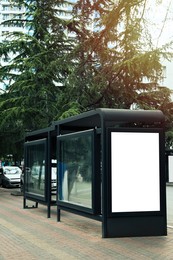 Photo of Blank advertising board on transport stop. Space for design