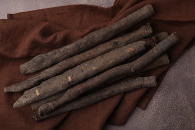 Photo of Raw salsify roots on brown table, flat lay