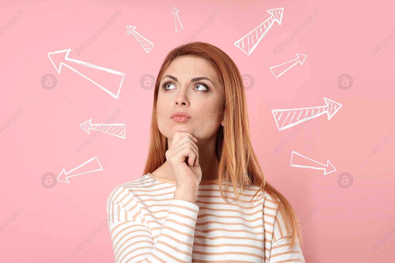 Image of Choice in profession or other areas of life, concept. Making decision, thoughtful woman surrounded by drawn arrows on pink background