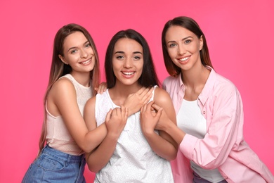 Photo of Happy women on pink background. Girl power concept