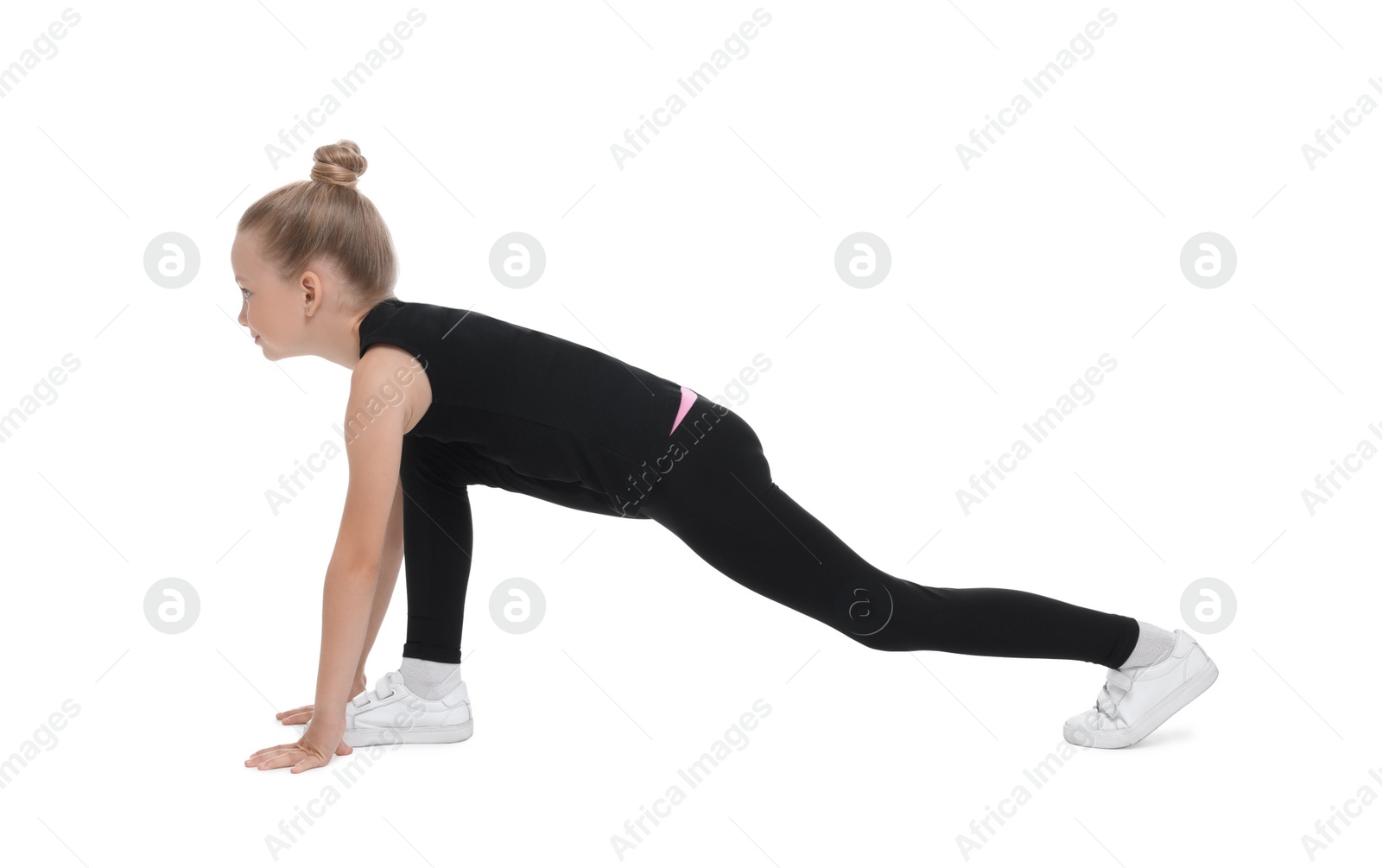 Photo of Little girl doing morning exercise on white background