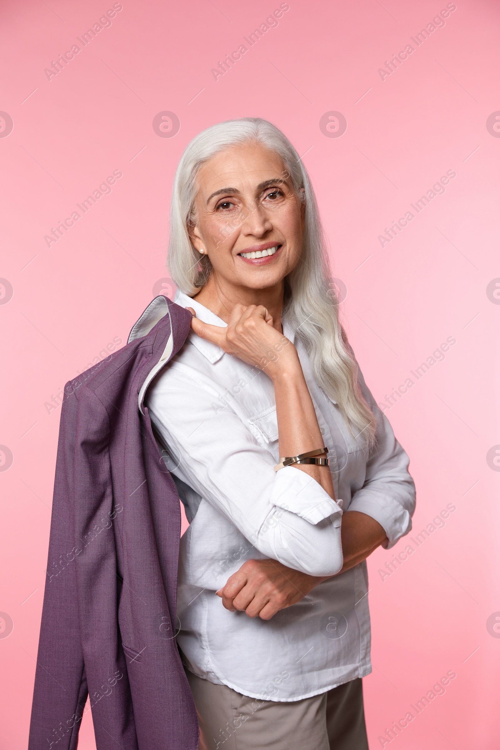 Photo of Portrait of beautiful mature woman on pink background