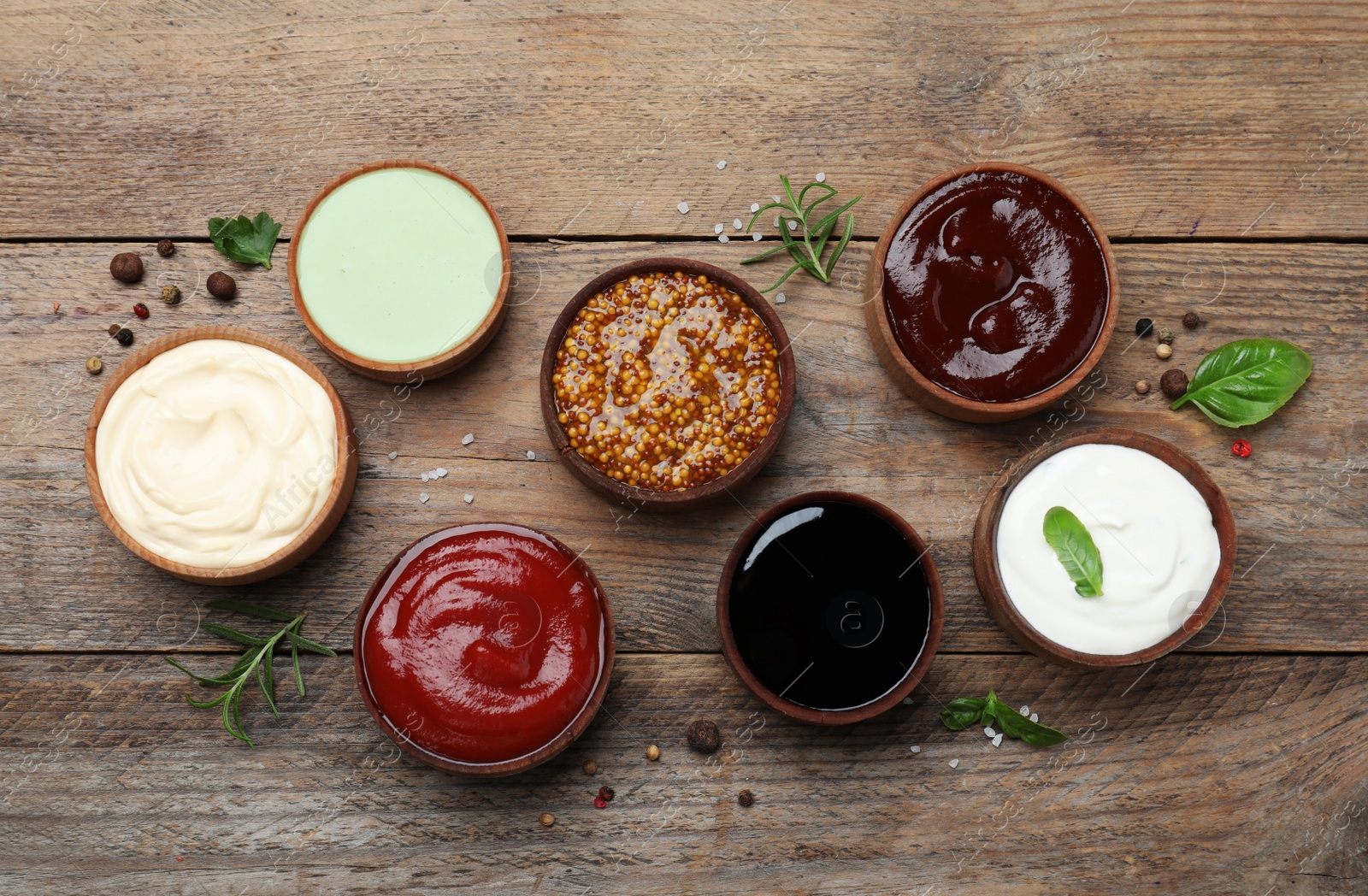 Photo of Many different sauces on wooden table, flat lay