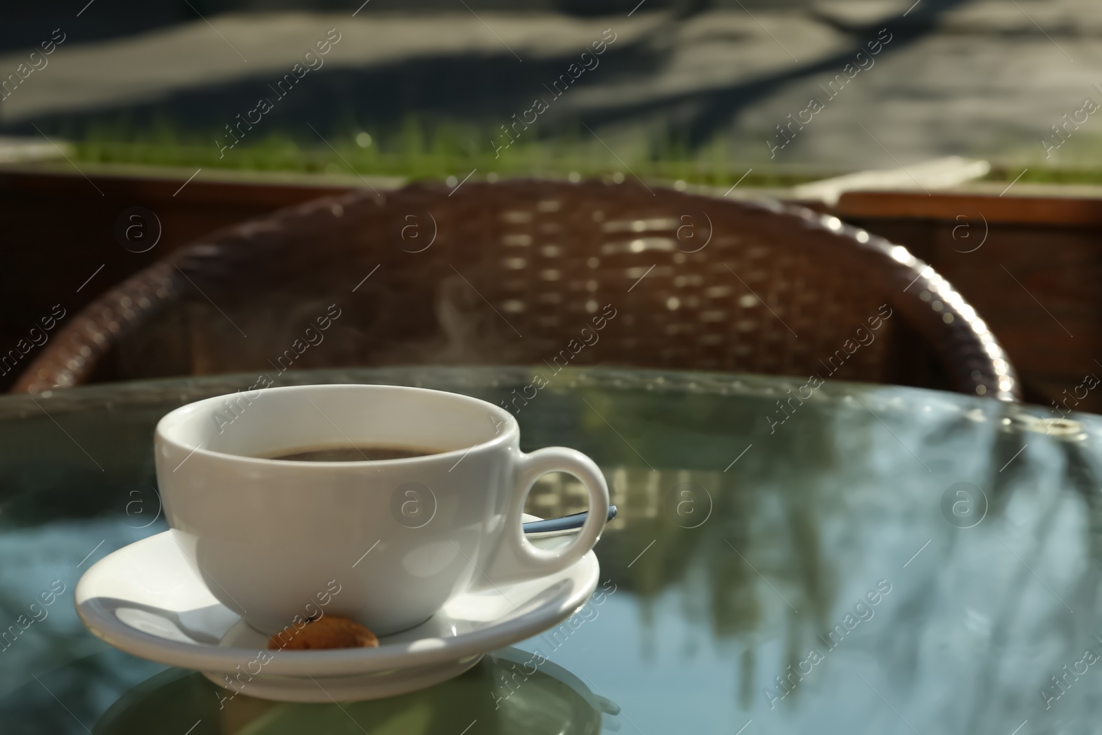 Photo of Cup of fresh aromatic coffee at table in cafe