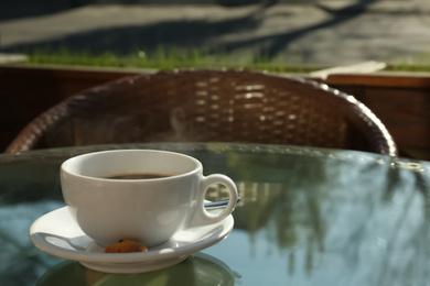 Photo of Cup of fresh aromatic coffee at table in cafe