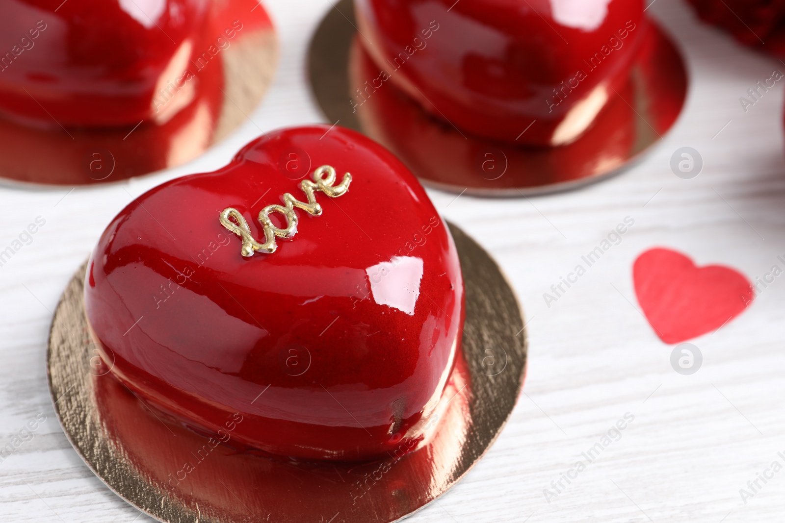 Photo of St. Valentine's Day. Delicious heart shaped cakes on white wooden table, closeup