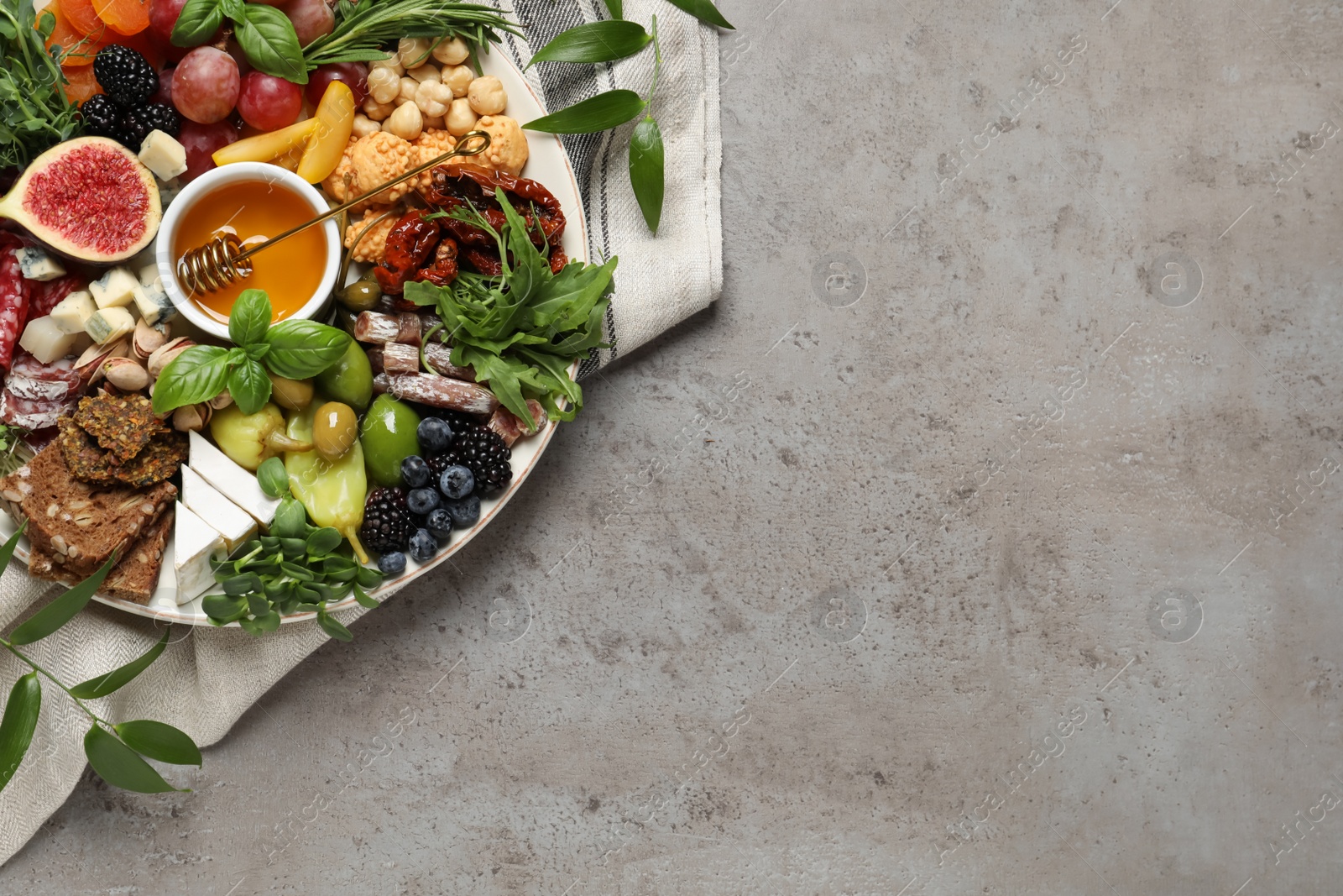 Photo of Set of different delicious appetizers served on light grey table, top view. Space for text