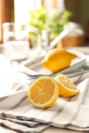 Halves of fresh ripe lemon on countertop in kitchen, space for text