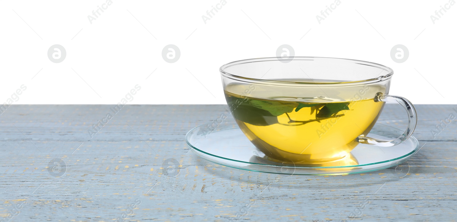 Photo of Refreshing green tea in cup on grey wooden table against white background