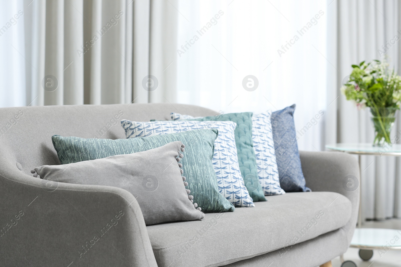 Photo of Sofa with pillows in modern living room interior