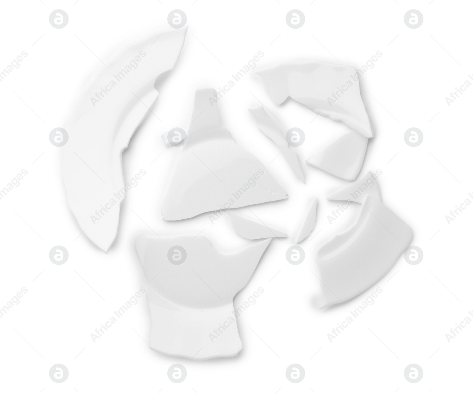 Photo of Pieces of broken ceramic plate on white background, top view