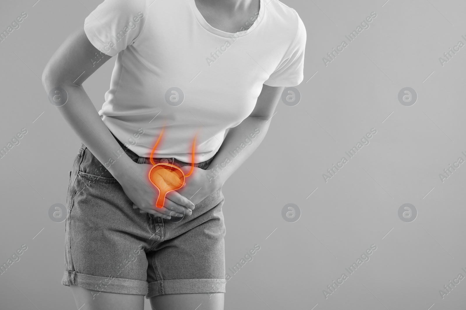 Image of Woman suffering from cystitis on light grey background, closeup. Illustration of urinary system