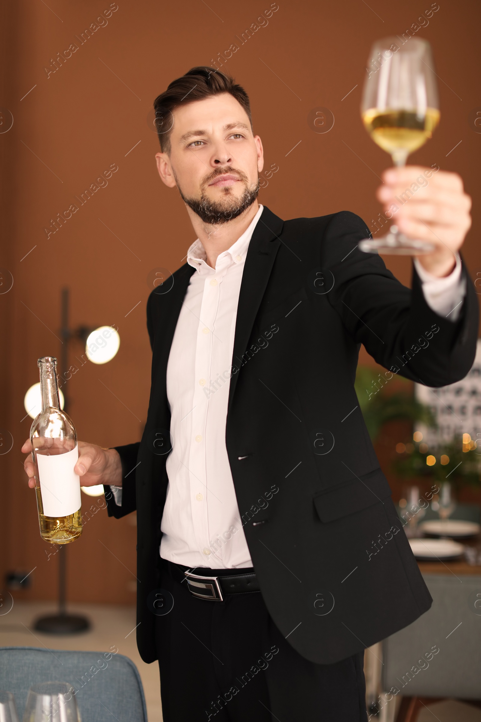 Photo of Young man with glass of wine indoors