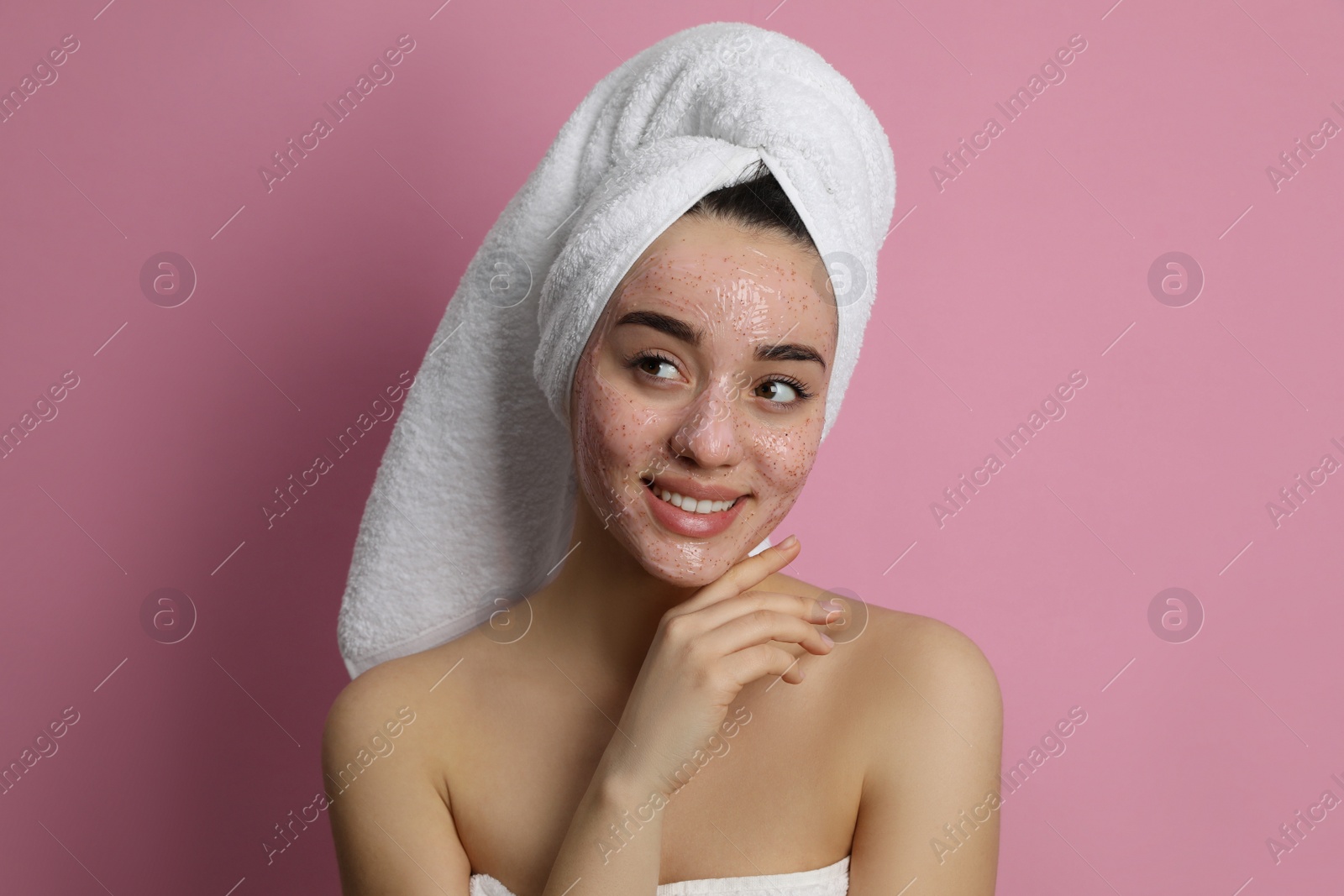 Photo of Woman with pomegranate face mask on pink background