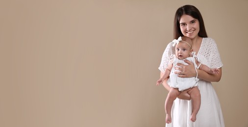 Image of Beautiful mother with her cute baby on beige background, space for text. Banner design 