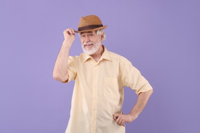 Photo of Portrait of stylish grandpa with hat on purple background