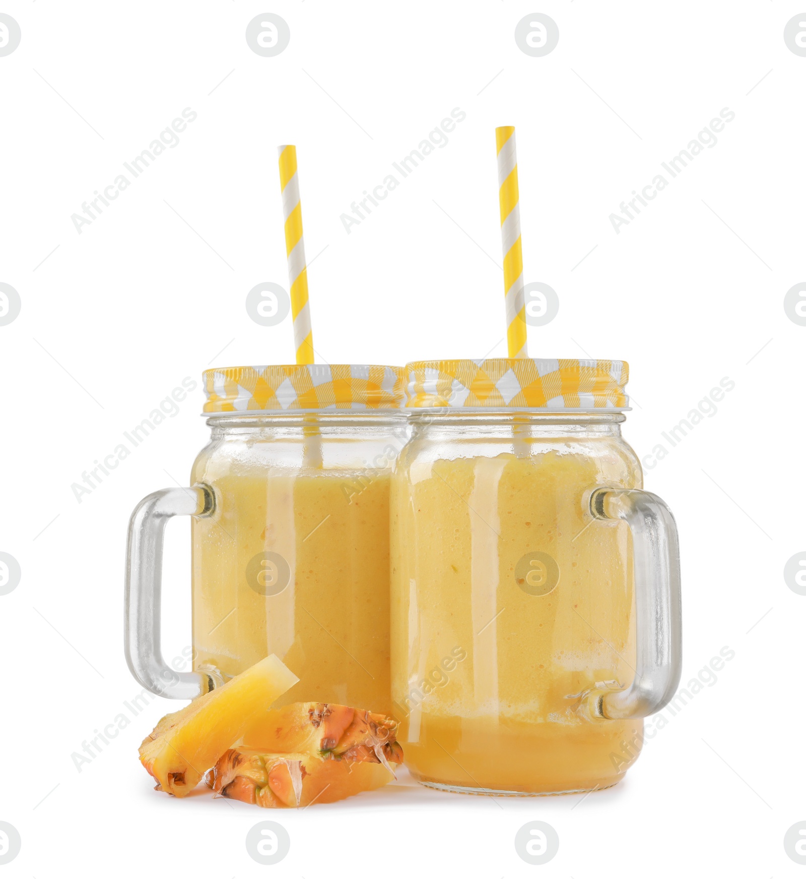 Photo of Tasty pineapple smoothie in mason jars and slices of fruit isolated on white