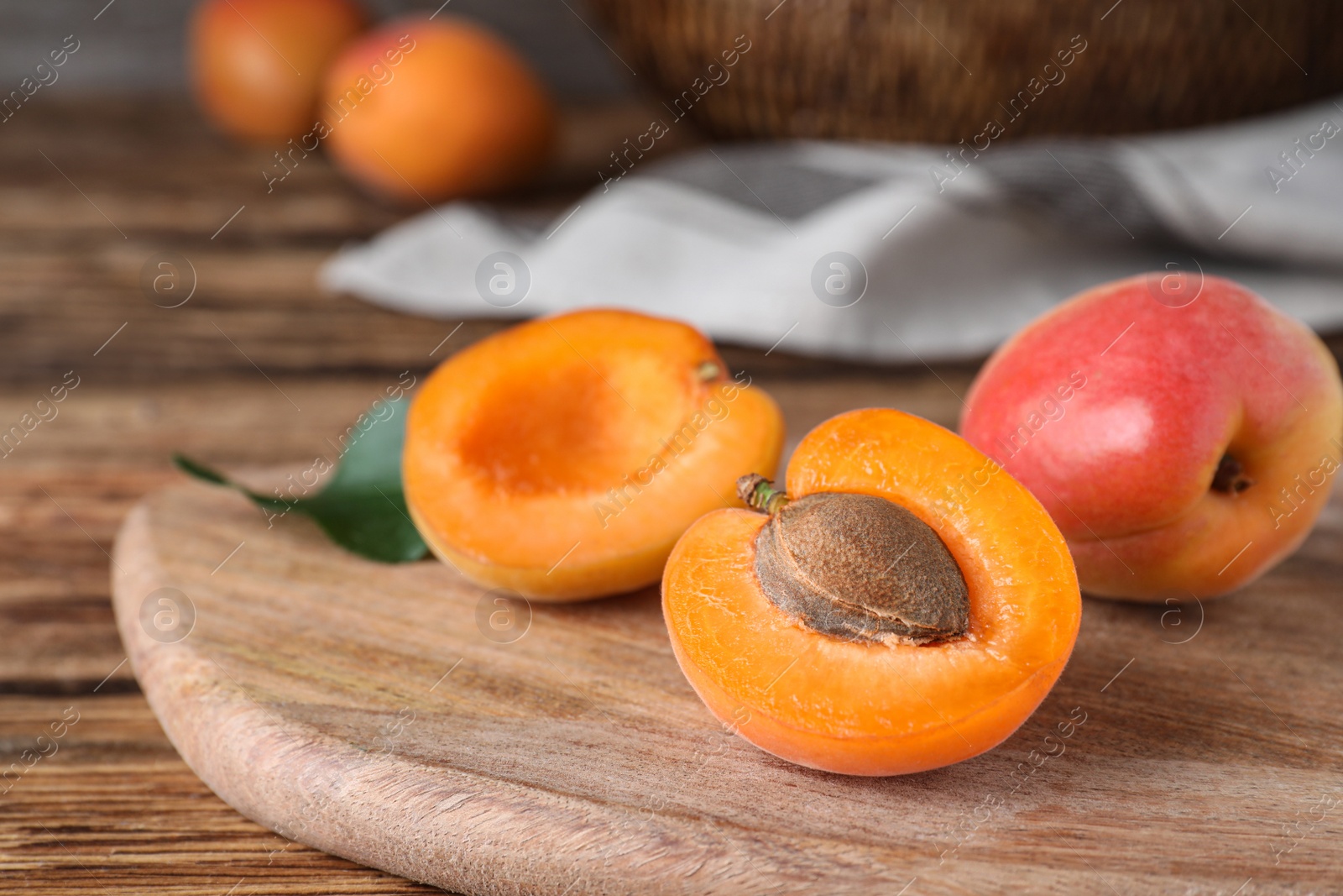 Photo of Delicious fresh ripe apricots on wooden table, closeup