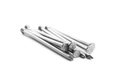 Photo of Pile of metal nails on white background