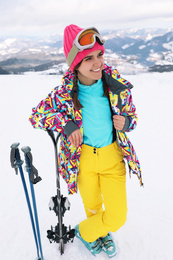 Photo of Young skier wearing winter sport clothes outdoors