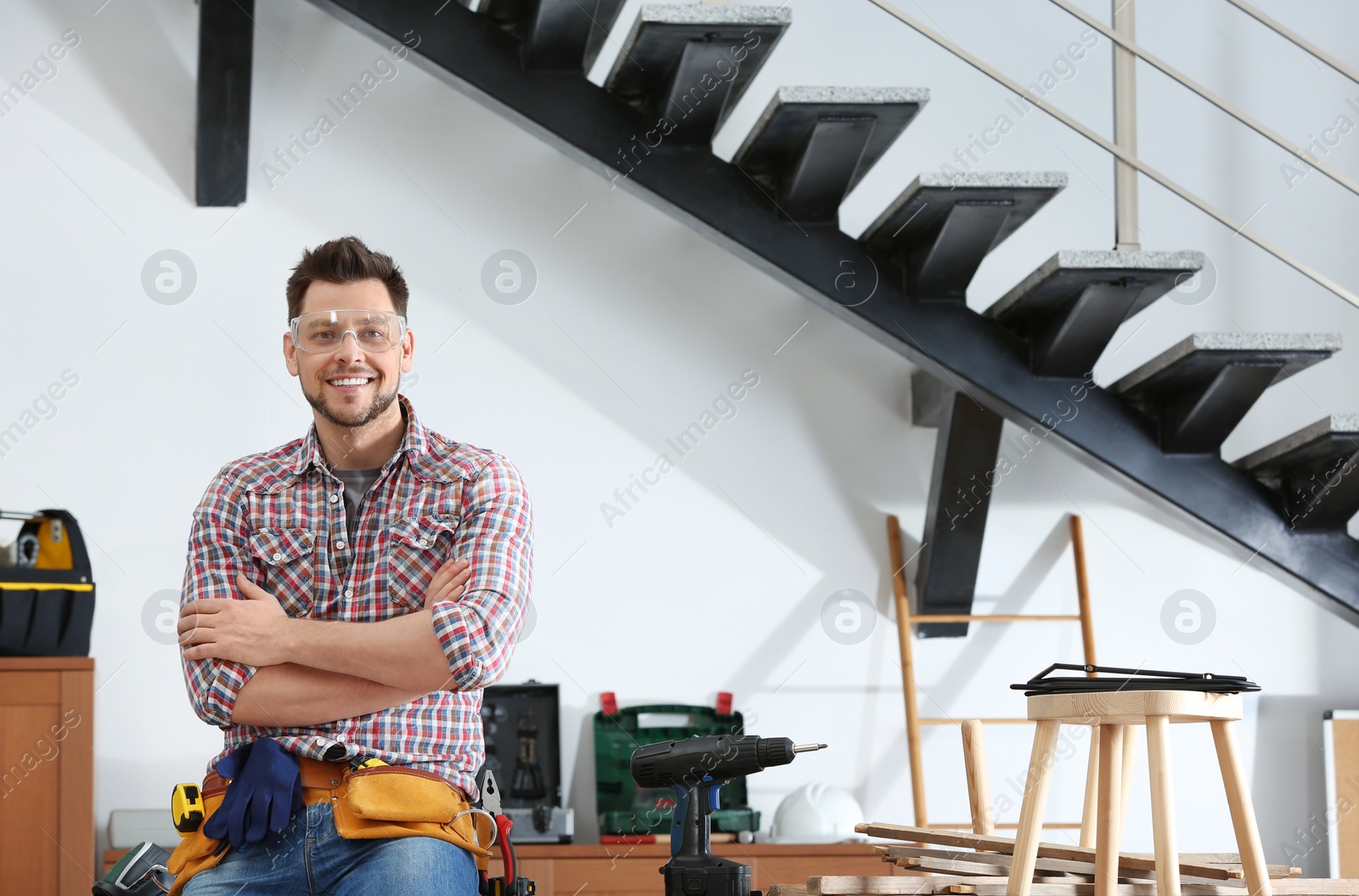 Photo of Handsome working man indoors, space for text. Home repair