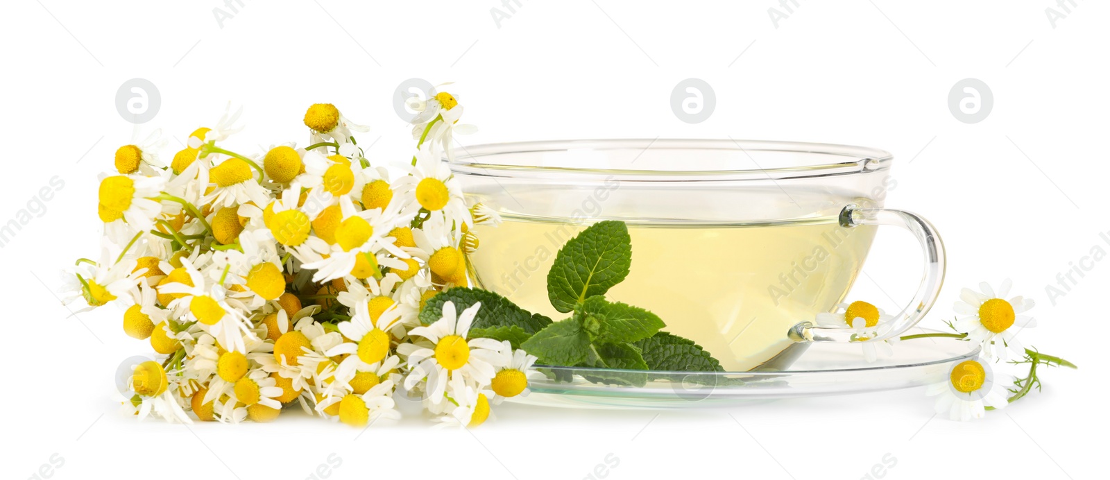 Photo of Aromatic herbal tea in glass cup with mint and chamomile flowers isolated on white