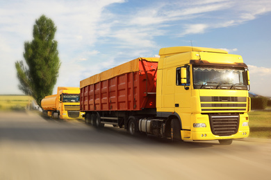 Image of Logistics concept. Trucks on country road, motion blur effect 