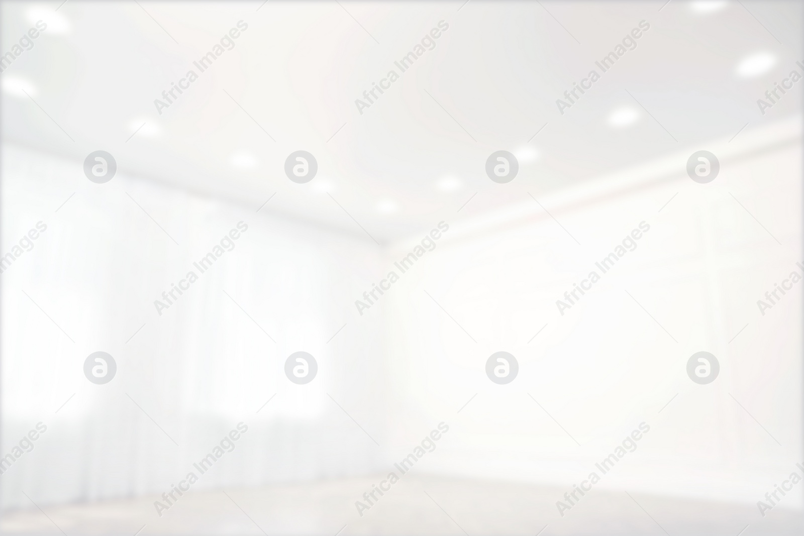 Image of Empty room with windows and white wall, blurred view