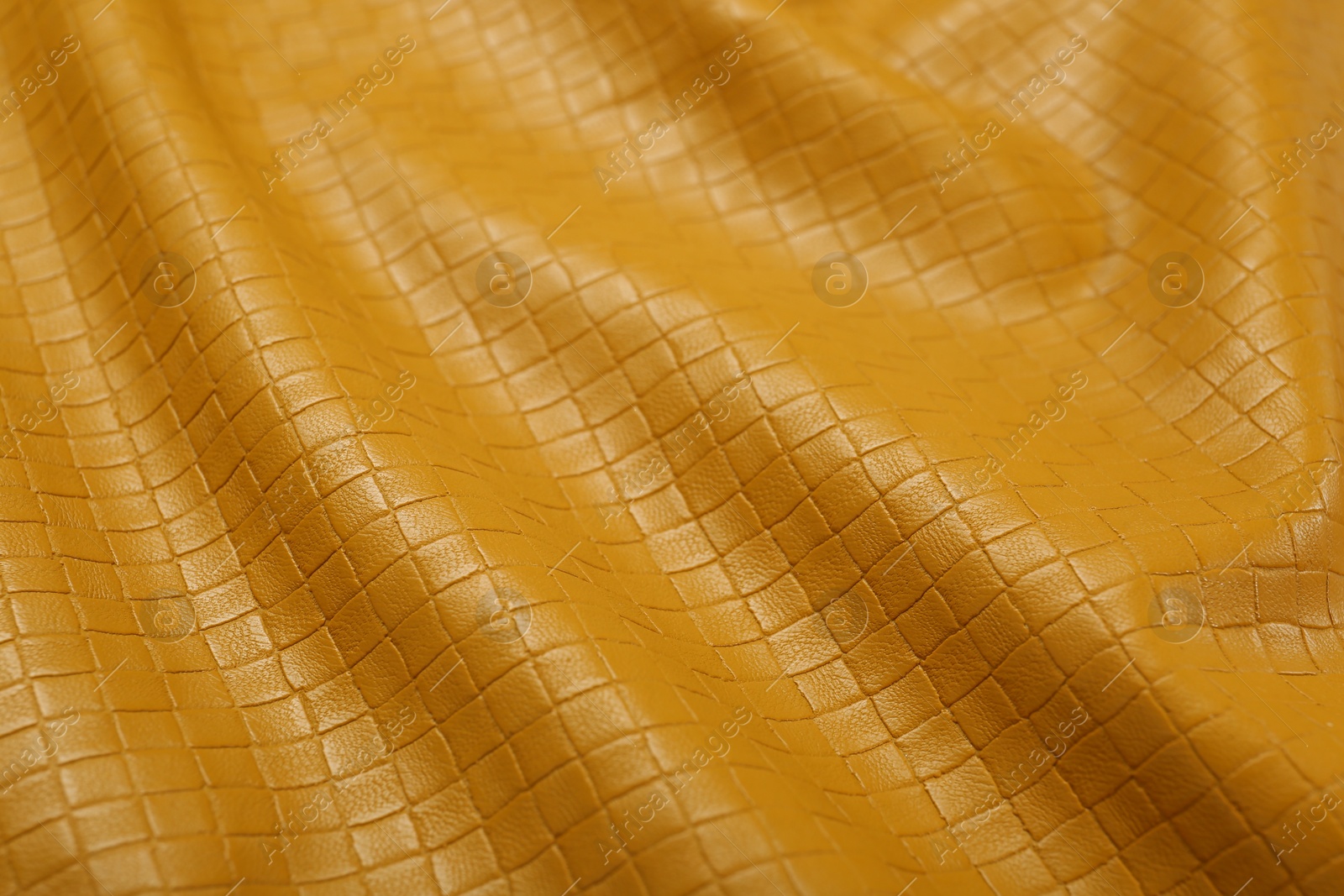 Photo of Beautiful yellow leather as background, closeup view