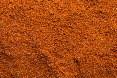 Photo of Ground red pepper as background, top view