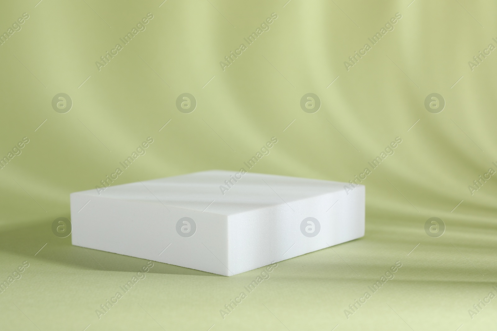 Photo of Presentation of product. Podium and shadows on light green background. Space for text