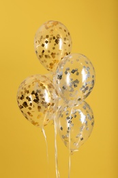 Photo of Bunch of bright balloons on color background