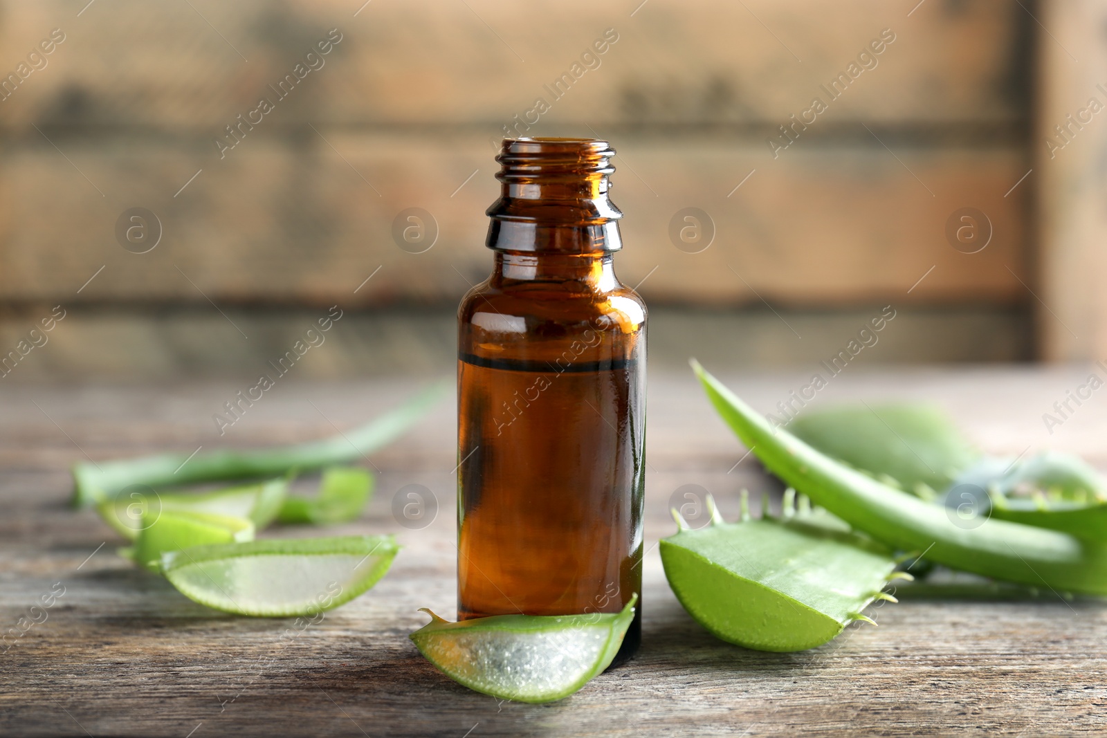 Photo of Bottle of aloe essential oil on table