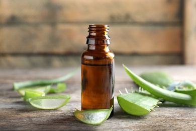 Bottle of aloe essential oil on table