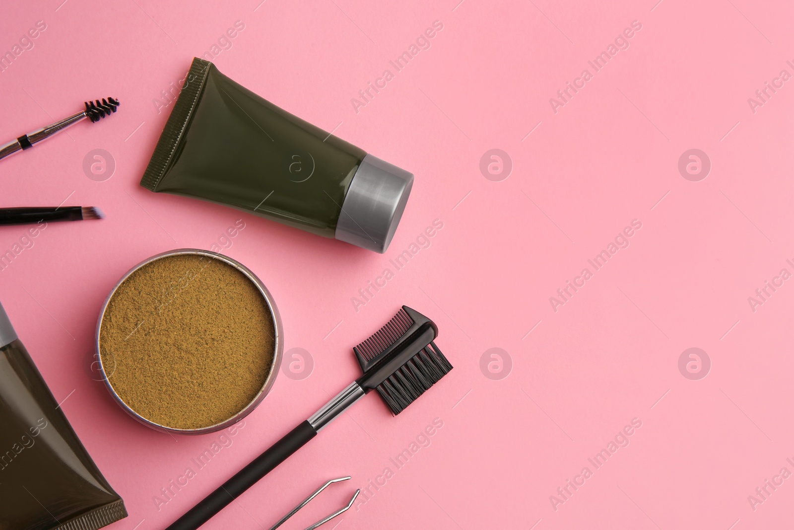 Photo of Flat lay composition with eyebrow henna and tools on pink background. Space for text