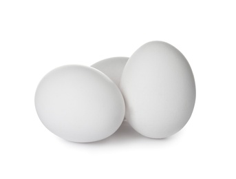 Photo of Few raw chicken eggs on white background