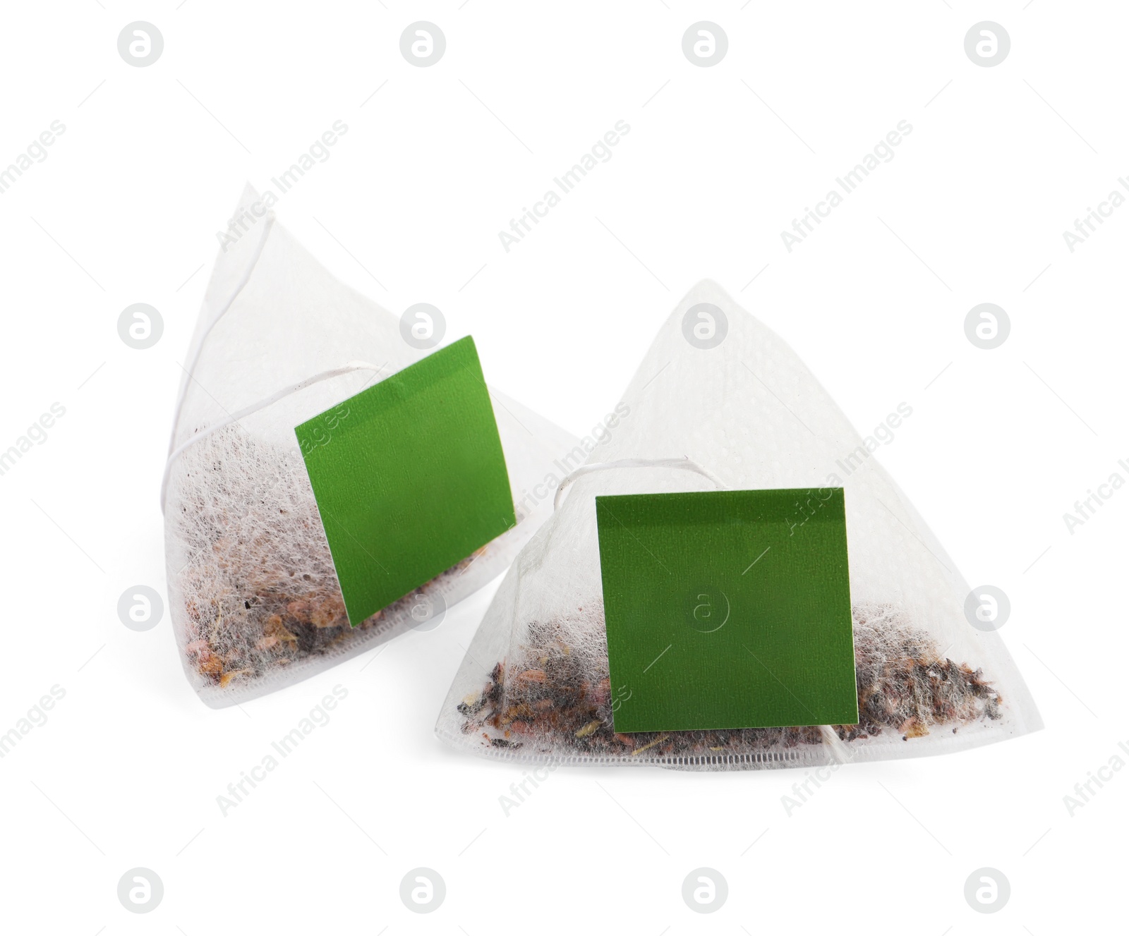 Photo of New pyramid tea bags on white background