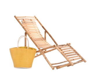 Wooden sun lounger and female bag on white background. Beach accessories