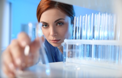 Female scientist working with sample in modern chemistry laboratory