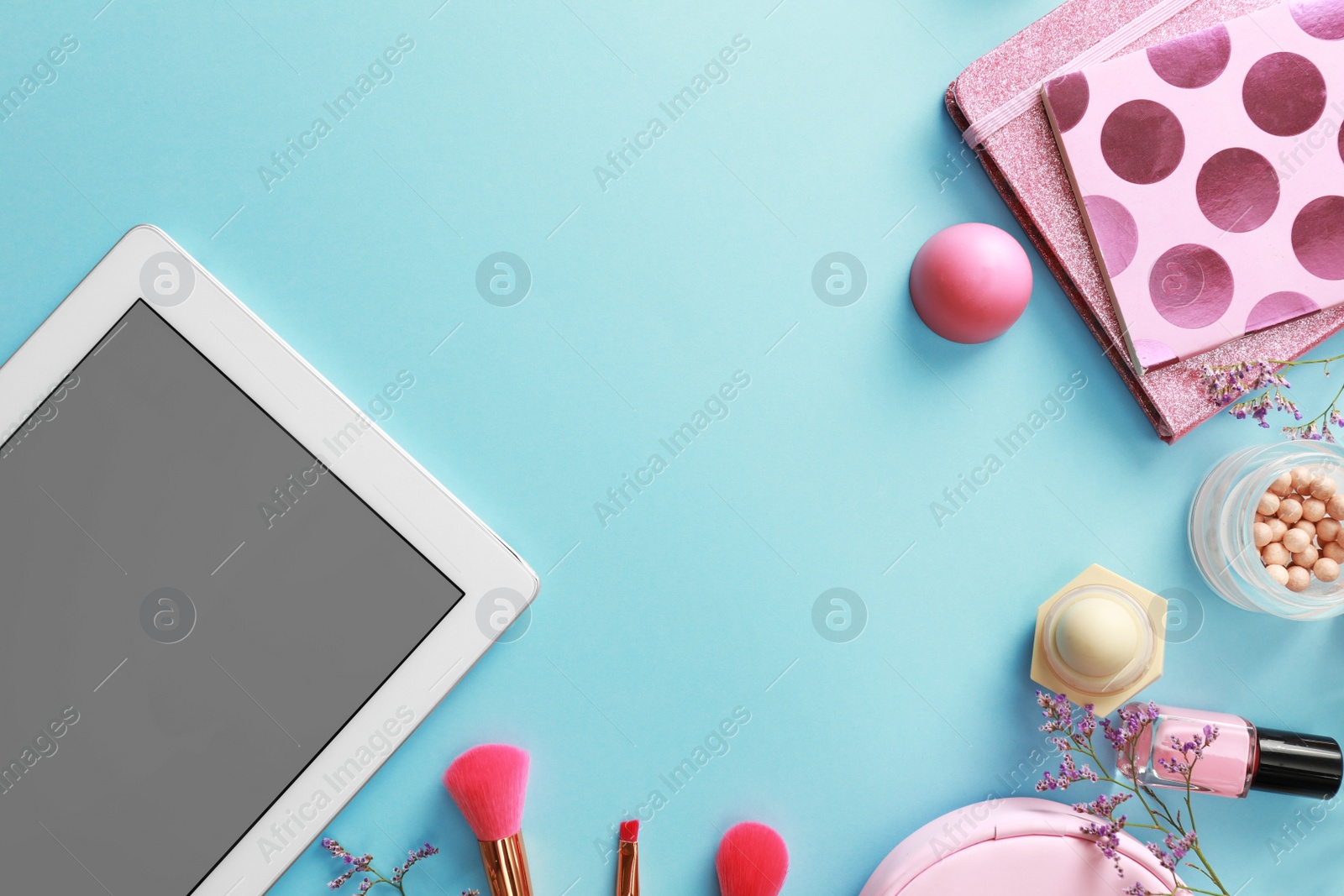 Photo of Flat lay composition with tablet on blue background. Beauty blogger's workplace