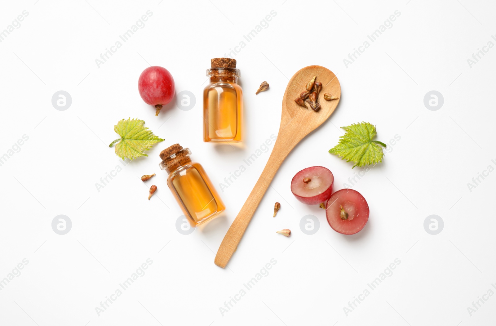 Photo of Composition with bottles of natural grape seed oil on white background, top view. Organic cosmetic