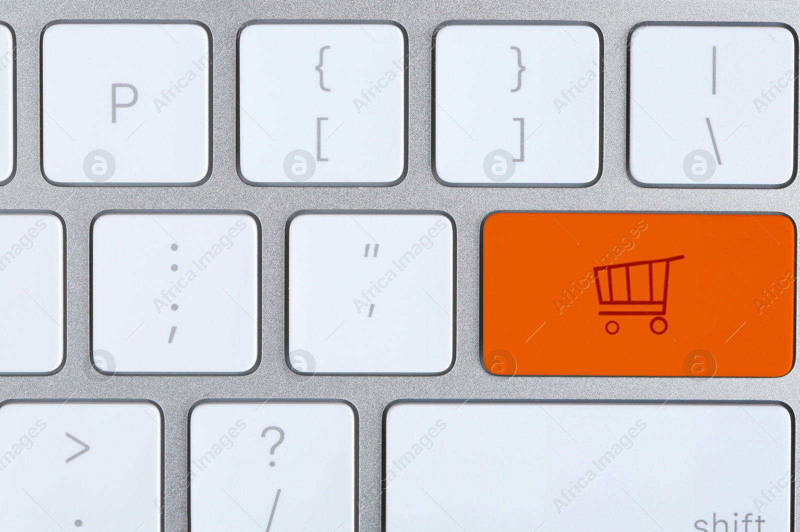 Image of Online store. Orange button with shopping cart on computer keyboard, top view