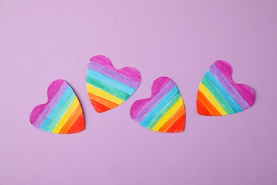 Rainbow hearts on color background, top view. Gay symbol