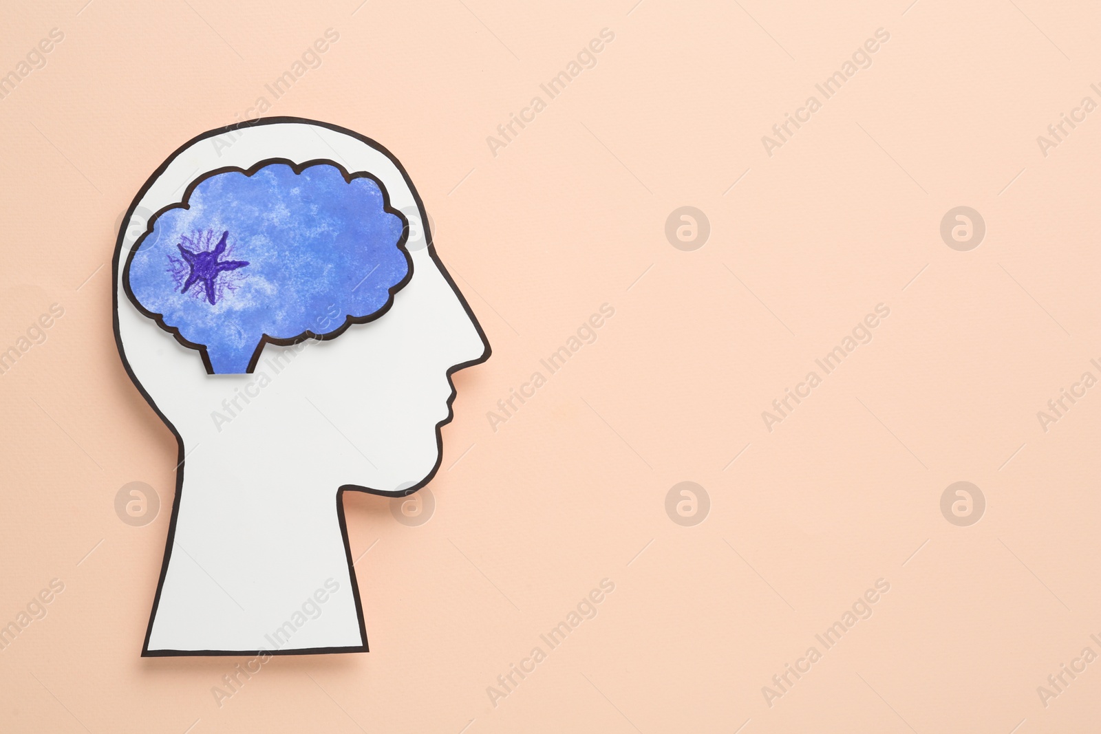 Photo of Top view of human head cutout with brain on beige background, space for text. Epilepsy awareness