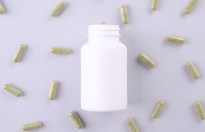 Photo of Jar with vitamin capsules on white background, flat lay