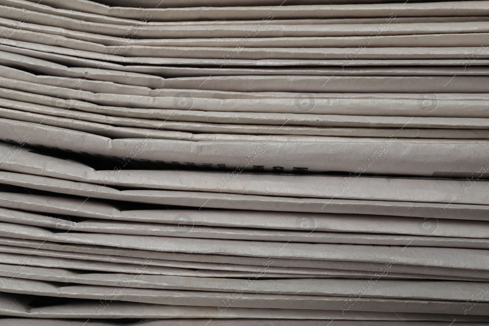 Photo of Stack of newspapers as background, closeup. Journalist's work